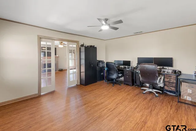 a view of a workspace with furniture and a window