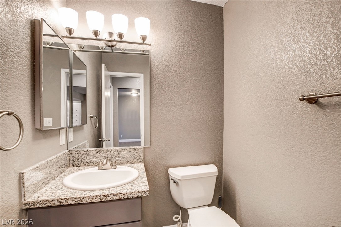 4367 South Mojave Road Las Vegas, NV 89121 - Photo 33 of 53 A well-appointed bathroom vanity with granite counters and an elegant overhead light fixture.