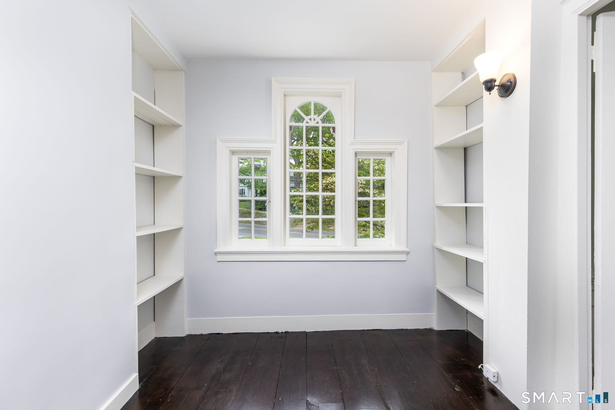79 Deforest Street Watertown, CT 06795 - Photo 19 of 28 a view of an empty room with a window and wooden floor