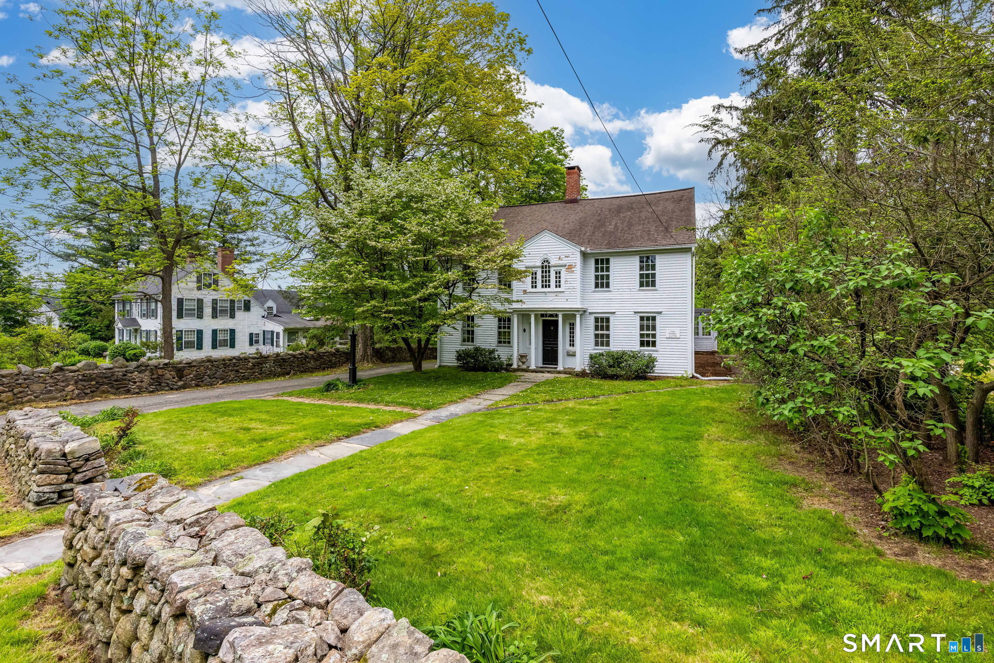 79 Deforest Street Watertown, CT 06795 - Photo 2 of 28 a view of a house with a big yard potted plants and large tree
