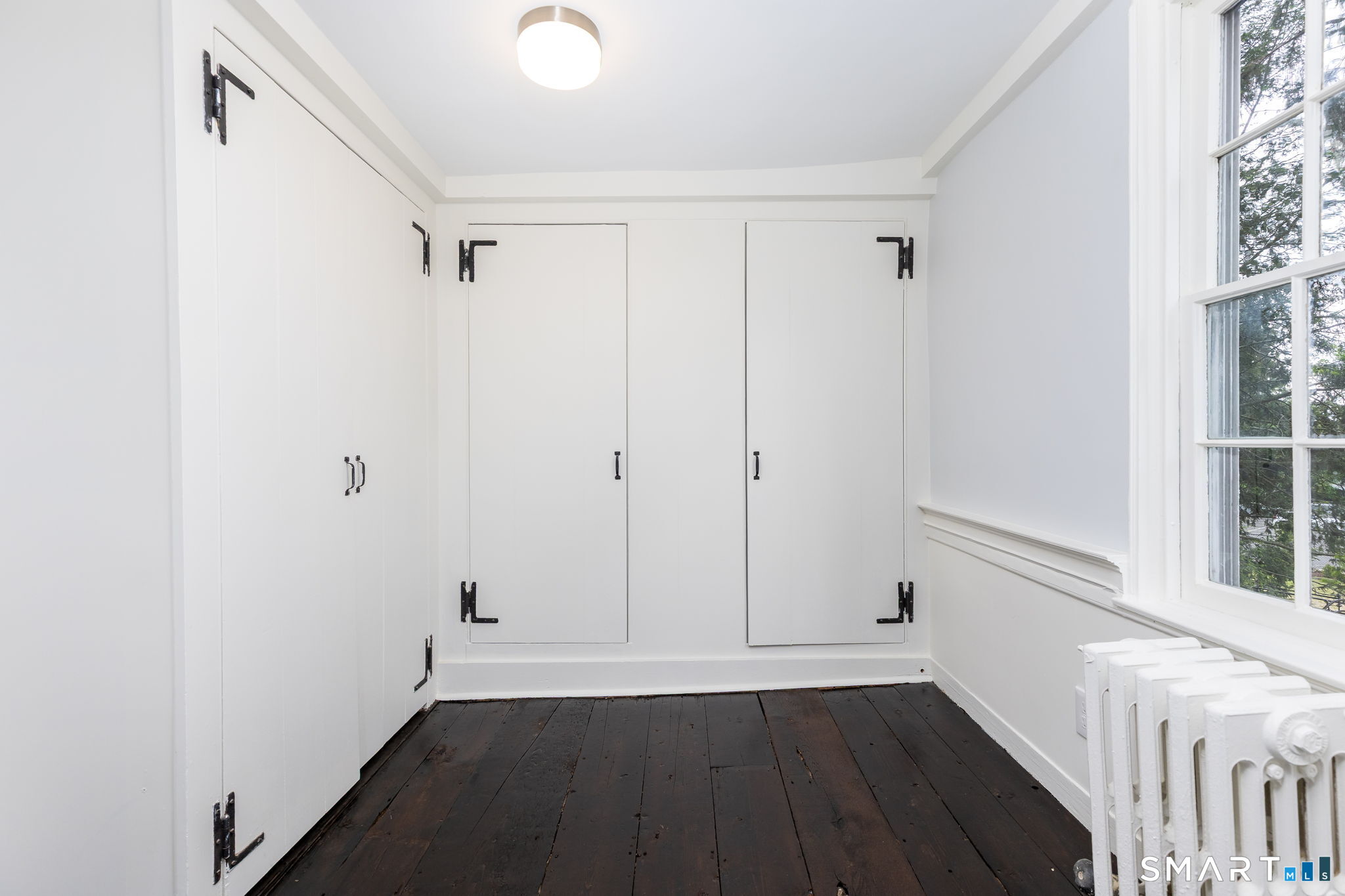 79 Deforest Street Watertown, CT 06795 - Photo 21 of 28 a view of an empty room with wooden floor and a window