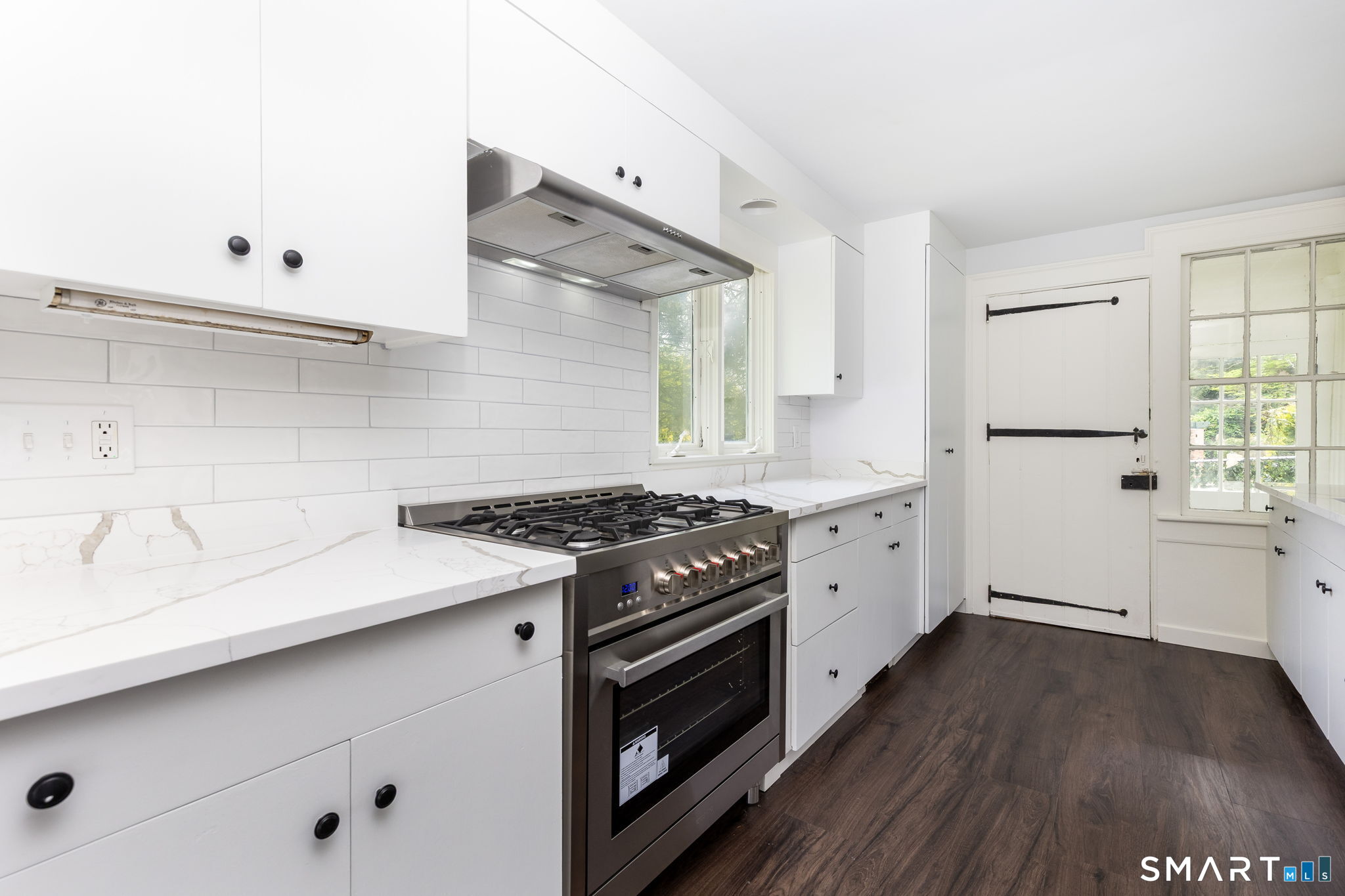 79 Deforest Street Watertown, CT 06795 - Photo 7 of 28 a kitchen with granite countertop a stove and a sink