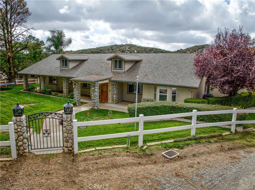a front view of a house with a garden and plants