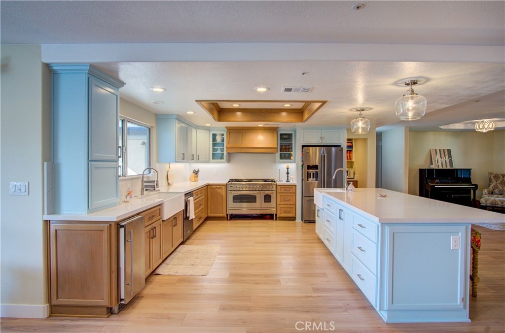 43350 Dunlap Street Banning, CA 92220 - Photo 11 of 21 a large kitchen with stainless steel appliances kitchen island a large counter top a sink a stove and a refrigerator