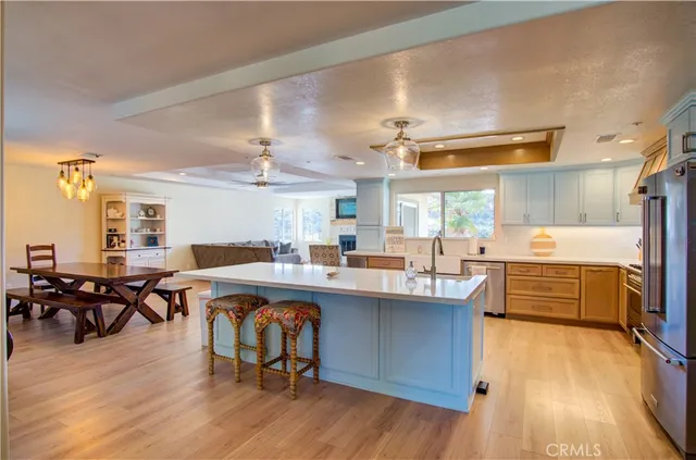 a large kitchen with lots of counter space a sink and chairs
