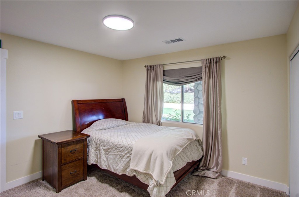 43350 Dunlap Street Banning, CA 92220 - Photo 20 of 21 a bedroom with a bed and window
