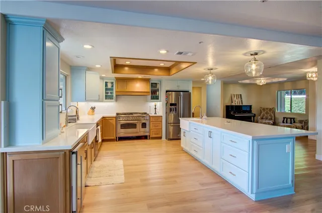 a large kitchen with a large counter top appliances and cabinets