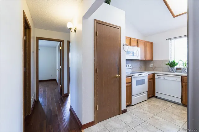 a kitchen with a refrigerator sink and stove top oven