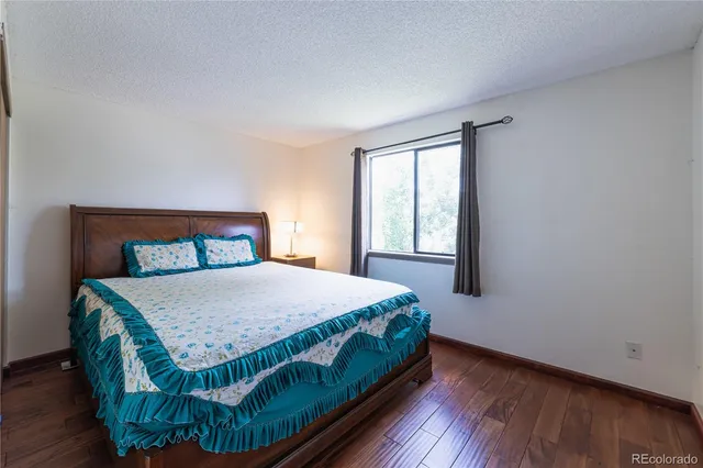 a bed sitting in a bedroom next to a window