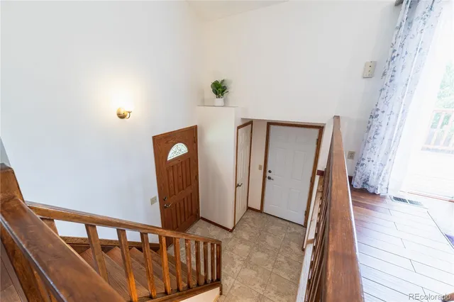 a view of a balcony with wooden floor and stairs