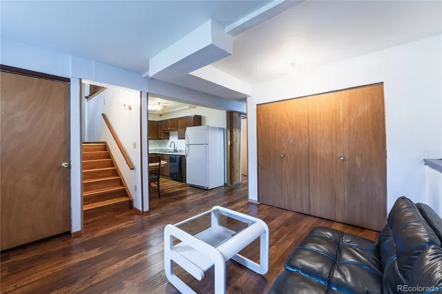 a view of a livingroom with furniture and stairs