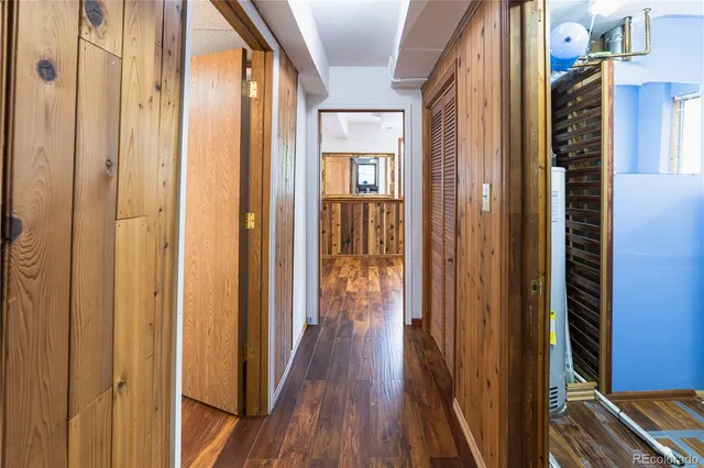 a view of a hallway with wooden floor and staircase