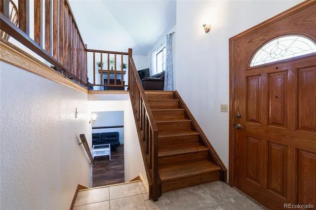 a view of entryway and hall with wooden floor