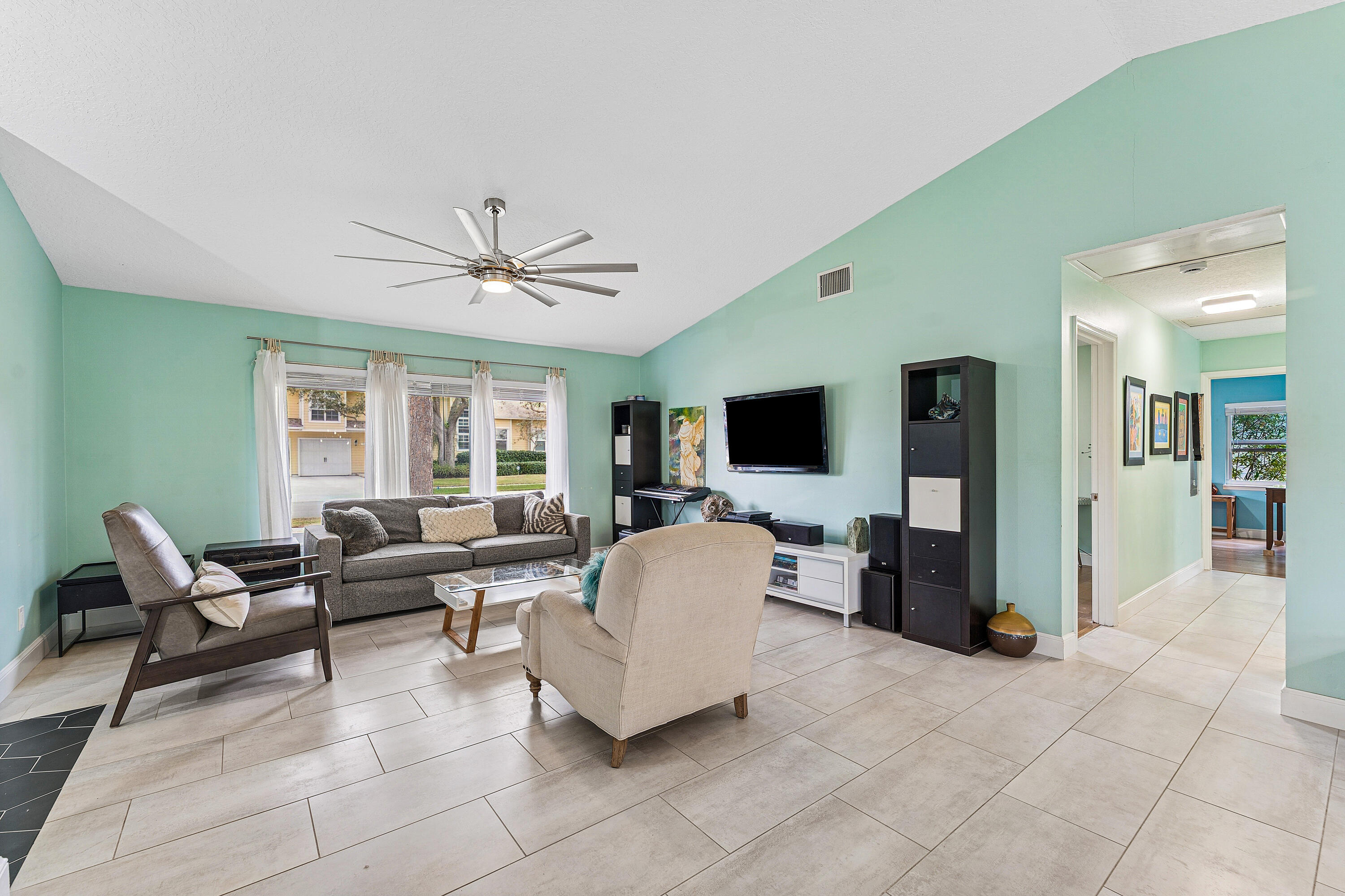 709 Warren Drive Jupiter, FL 33458 - Photo 14 of 56 a living room with furniture and a flat screen tv