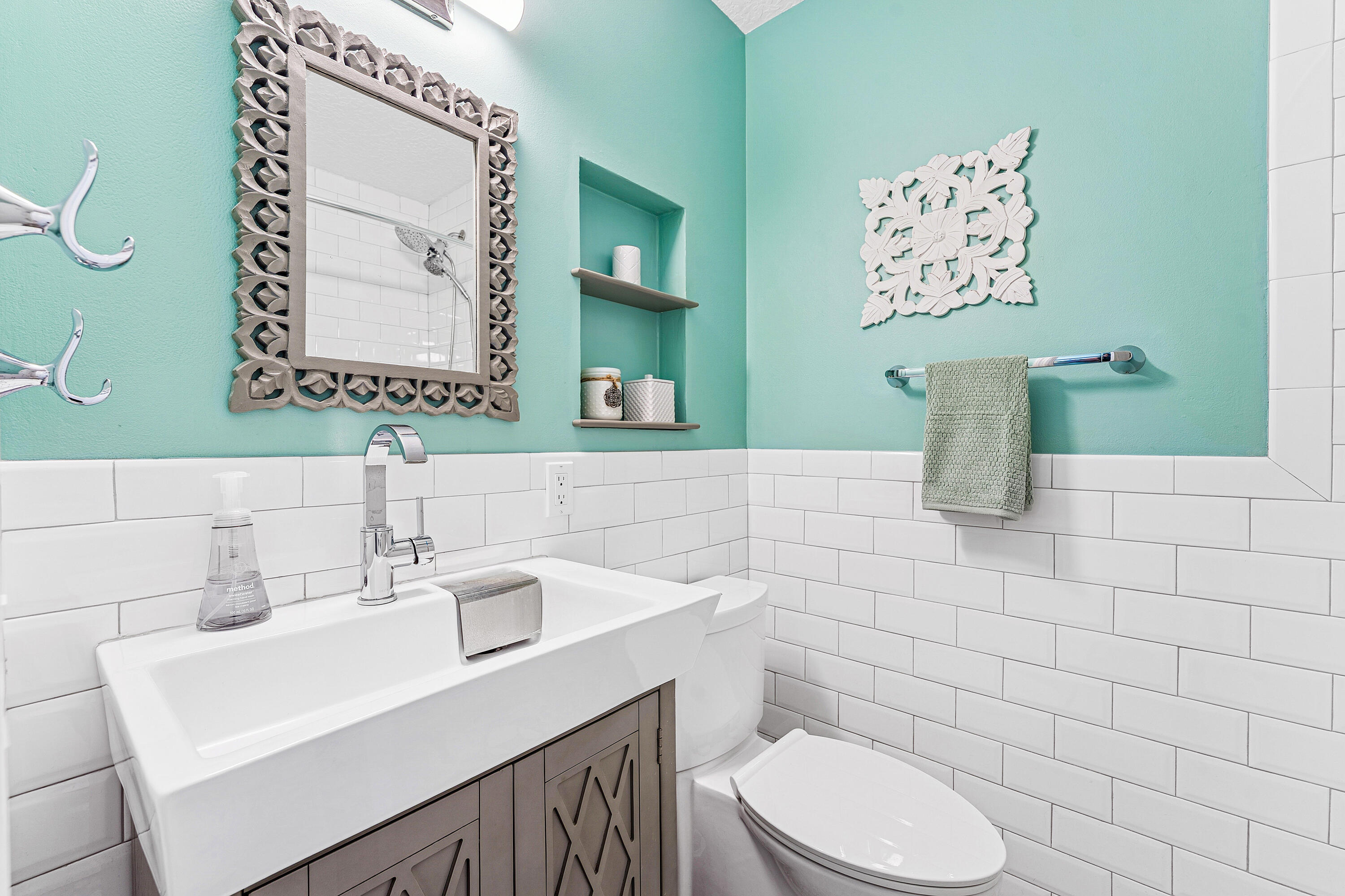 709 Warren Drive Jupiter, FL 33458 - Photo 19 of 56 a bathroom with a toilet sink and mirror