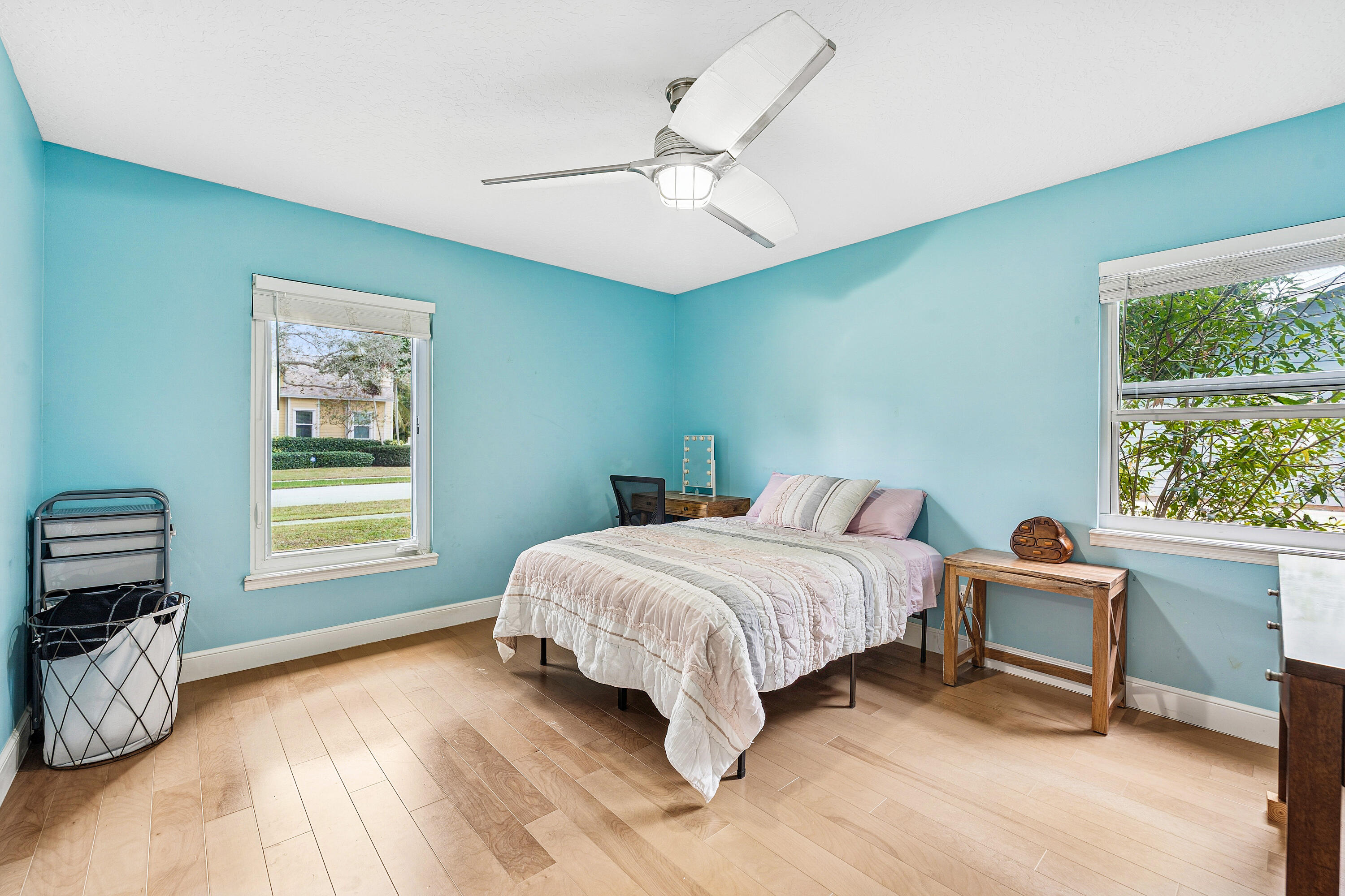 709 Warren Drive Jupiter, FL 33458 - Photo 22 of 56 a bedroom with a bed a chandelier and a window