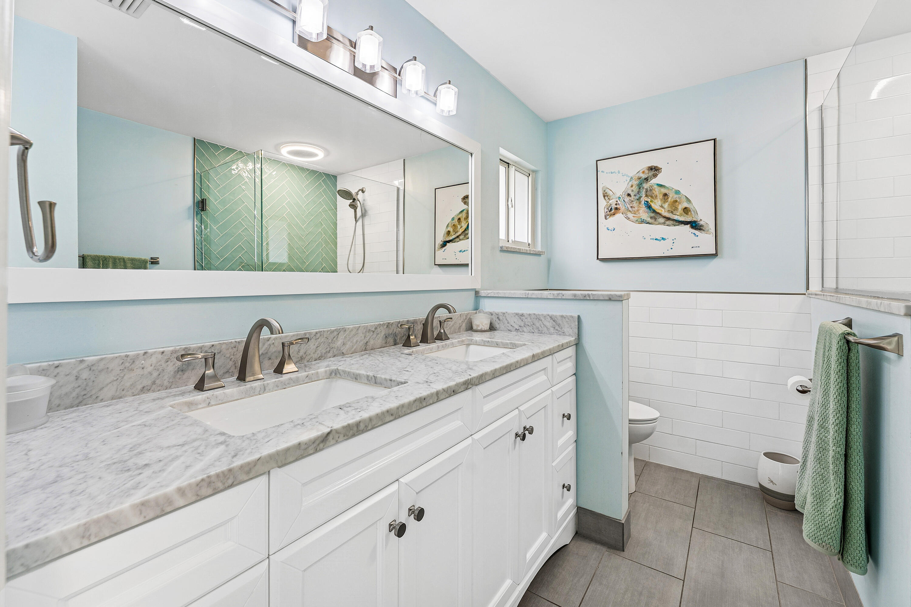 709 Warren Drive Jupiter, FL 33458 - Photo 26 of 56 a bathroom with a granite countertop sink mirror and toilet