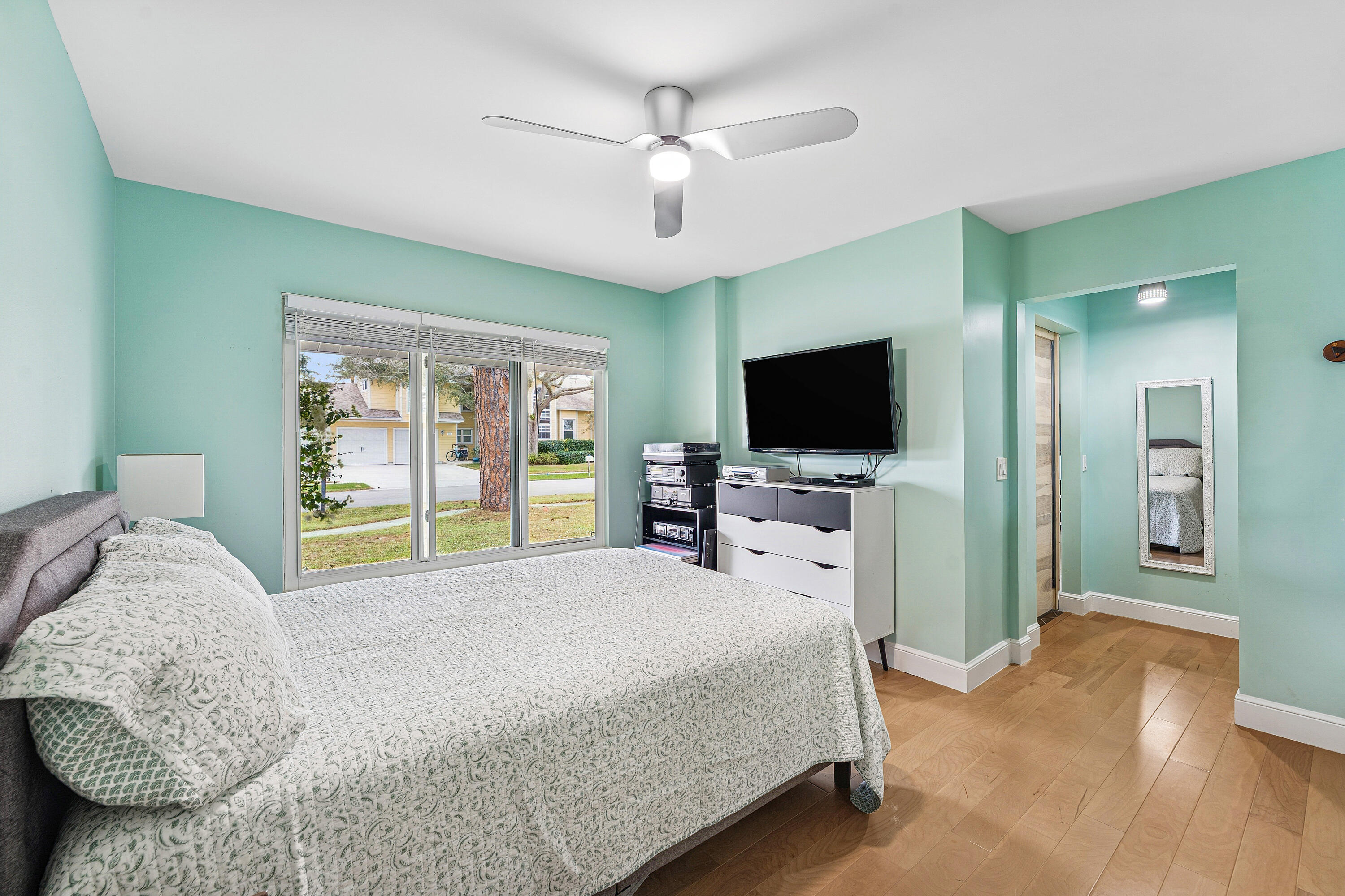 709 Warren Drive Jupiter, FL 33458 - Photo 31 of 56 a bedroom with a large bed and flat tv