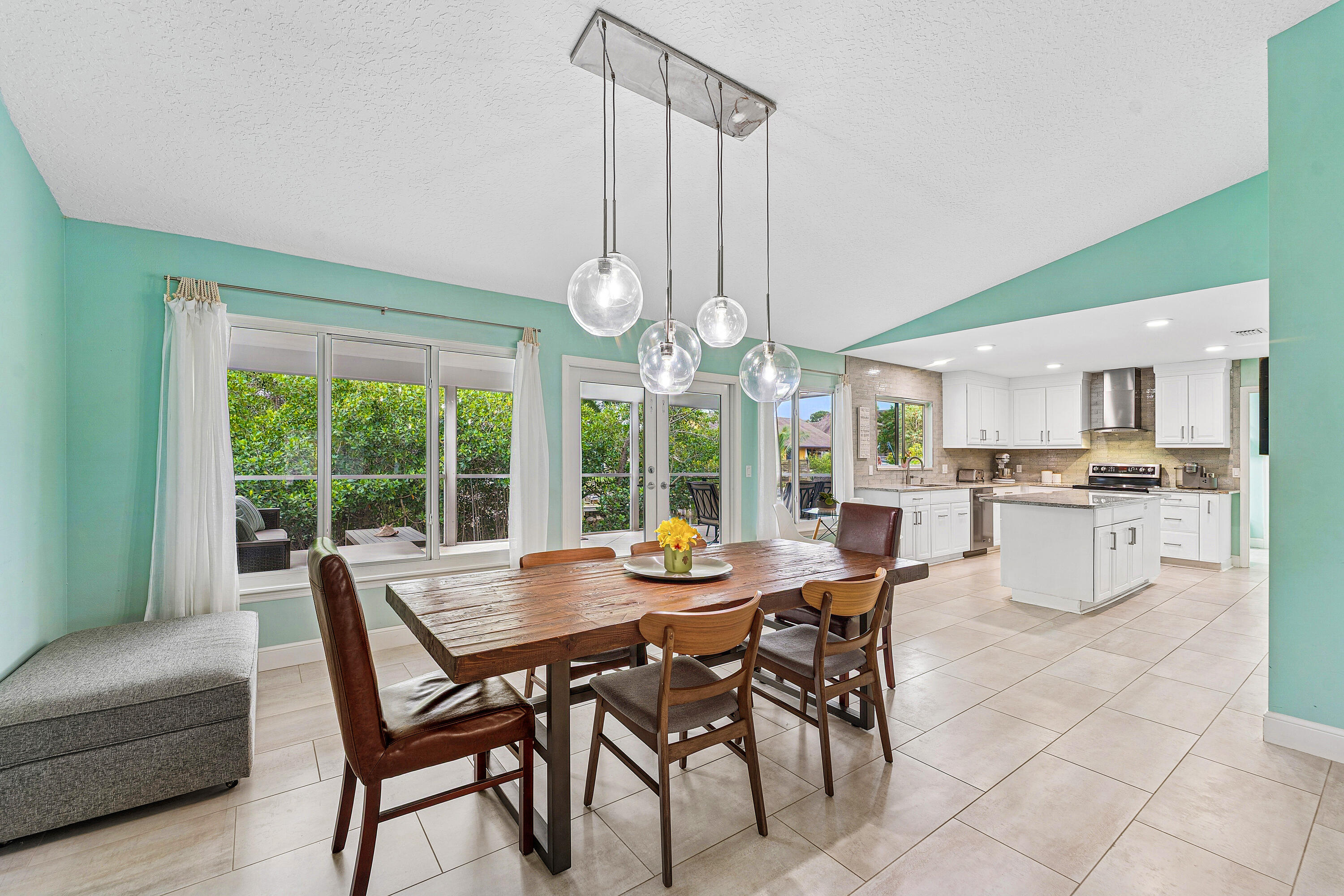 709 Warren Drive Jupiter, FL 33458 - Photo 10 of 56 a dining room with furniture a chandelier and a rug