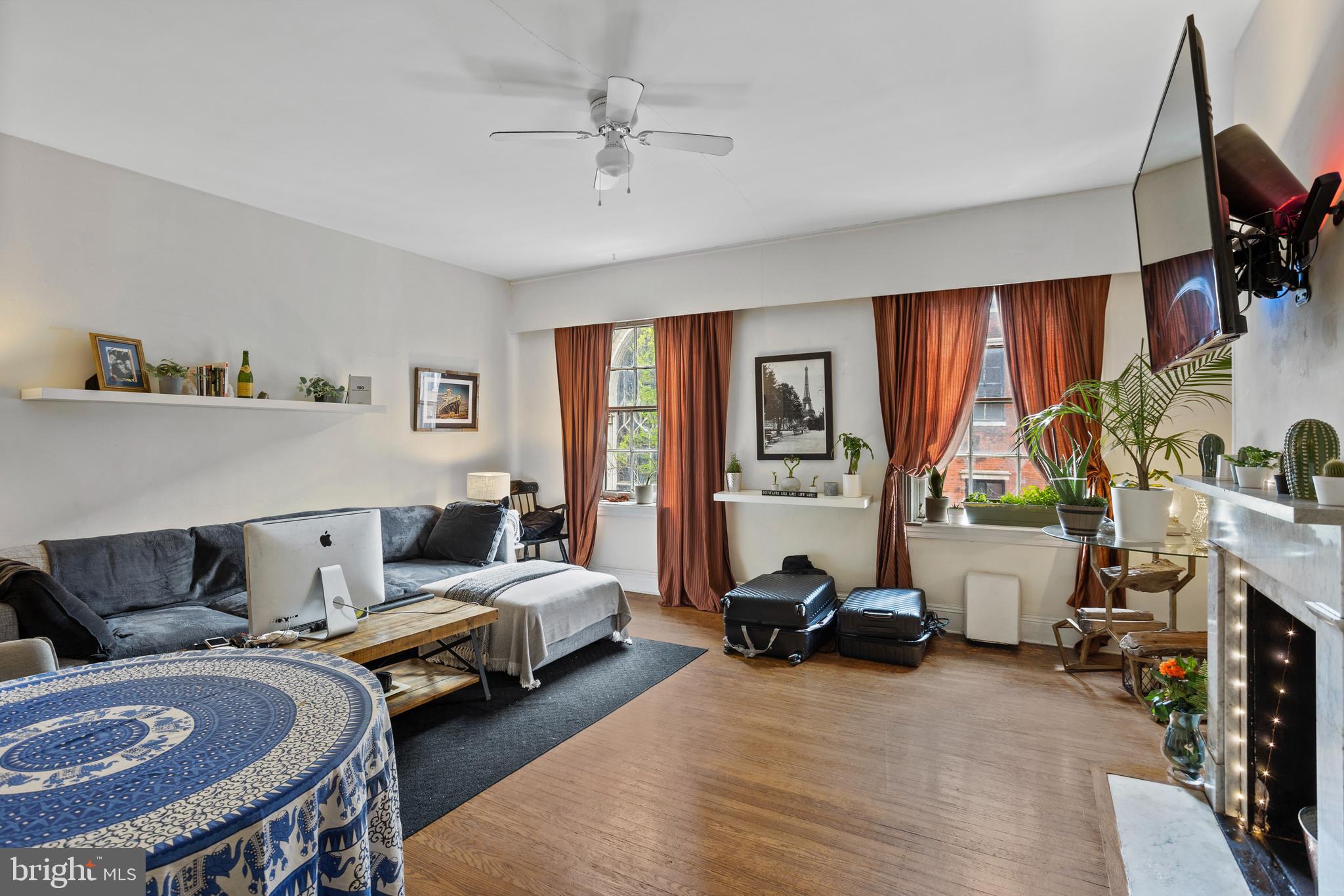 a living room with furniture a ceiling fan and a window