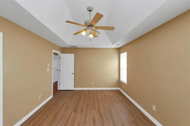 wooden floor in an empty room with a window