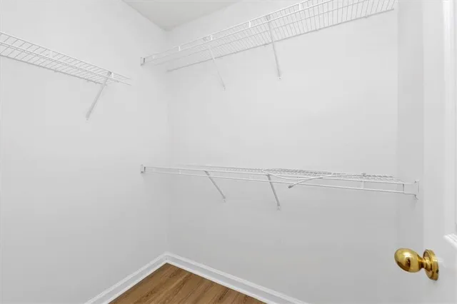 a bathroom with a granite countertop sink a mirror and a bathtub