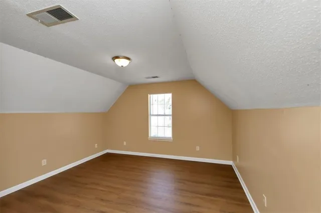 a view of a room with wooden floor