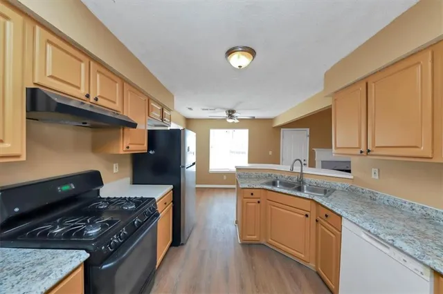 a kitchen with granite countertop cabinets and window