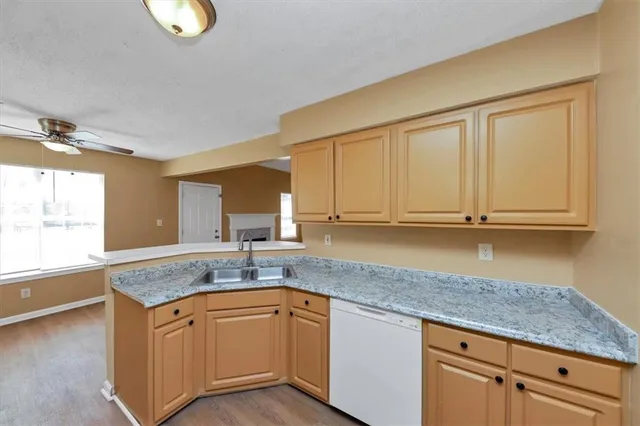 a kitchen with stainless steel appliances granite countertop a refrigerator stove a sink and dishwasher