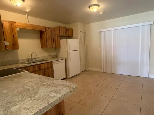 a kitchen with stainless steel appliances a refrigerator sink and stove