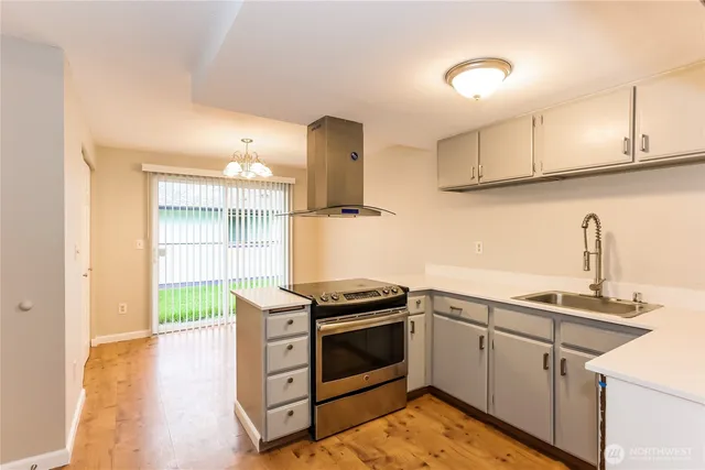 a kitchen with stainless steel appliances granite countertop a stove and a sink