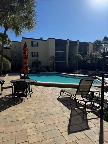 a backyard of a house with table and chairs