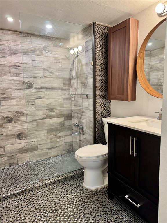 106 Alameda Court, Unit 139 Tampa, FL 33609 - Photo 8 of 13 a bathroom with a sink a toilet and a mirror