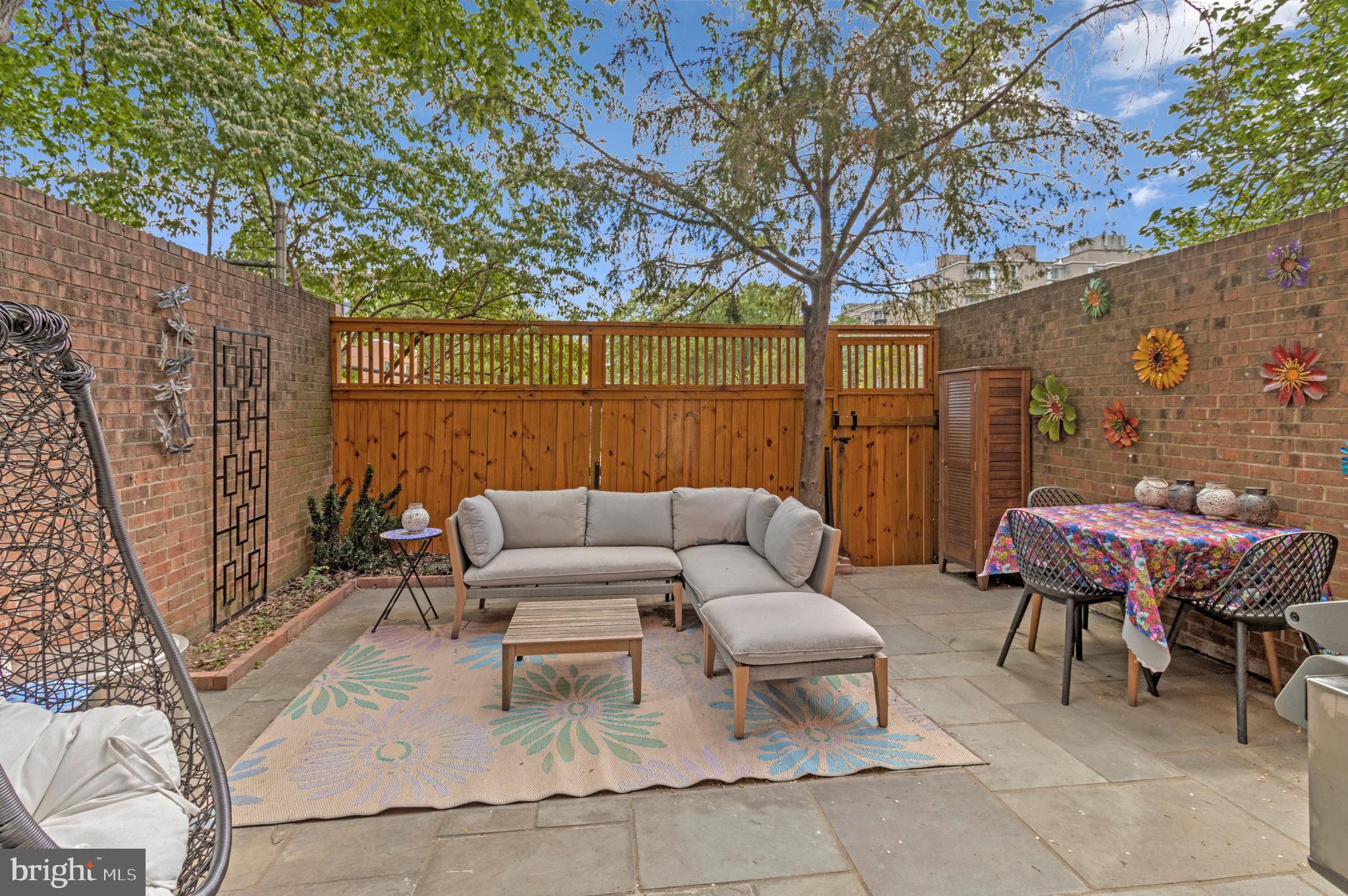 500 H Street Southwest Washington, DC 20024 - Photo 22 of 54 a view of a patio with couches and a table and chairs with wooden fence and plants