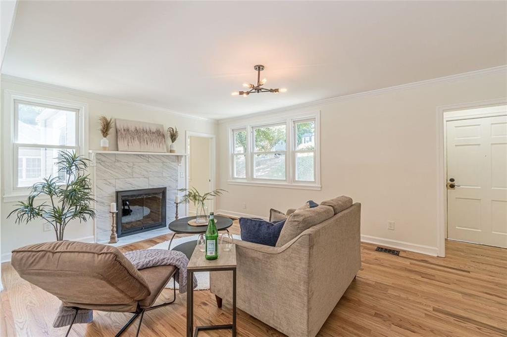 1226 Thomas Road Decatur, GA 30030 - Photo 16 of 38 a living room with furniture a fireplace and a window