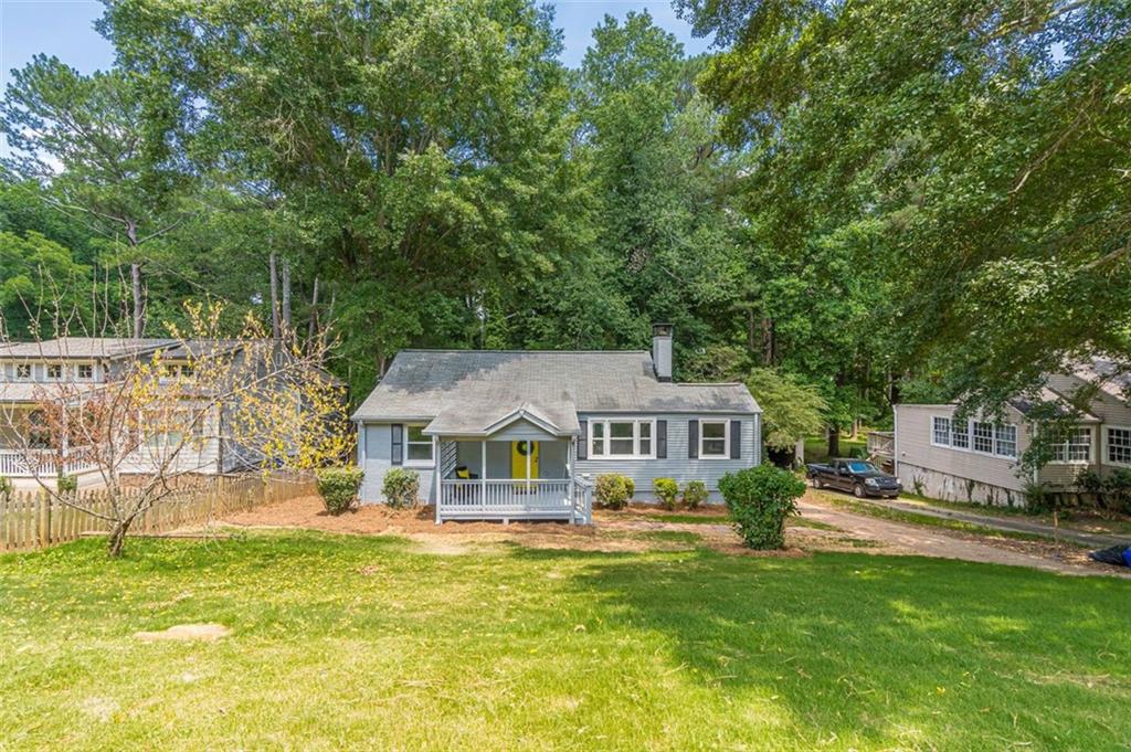 1226 Thomas Road Decatur, GA 30030 - Photo 2 of 38 a front view of a house with a yard table and chairs