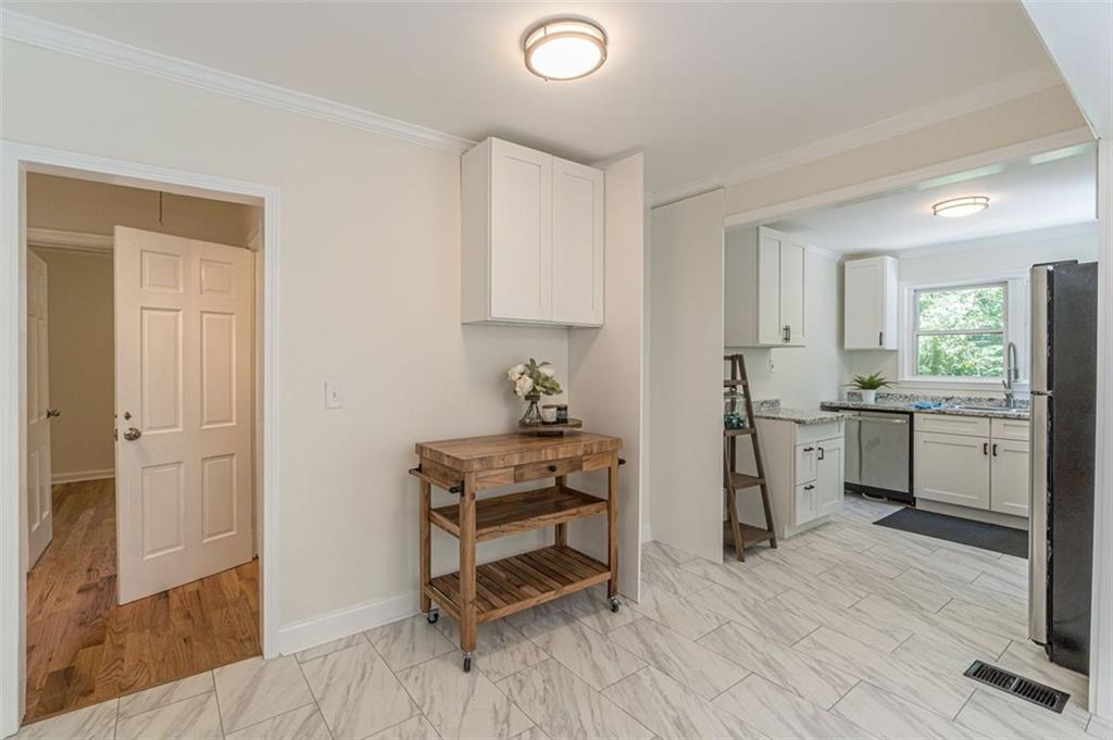 1226 Thomas Road Decatur, GA 30030 - Photo 25 of 38 a kitchen with white cabinets and appliances