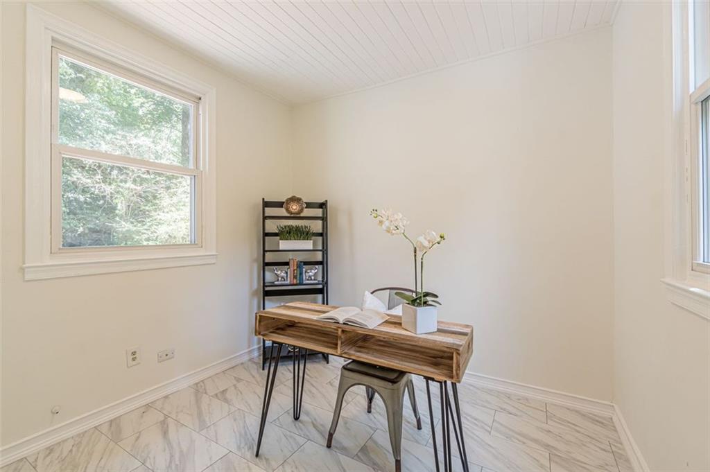 1226 Thomas Road Decatur, GA 30030 - Photo 31 of 38 a view of a workspace with furniture and a window