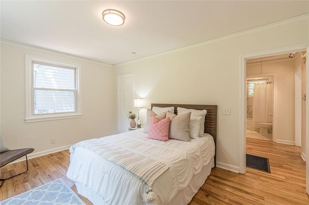 1226 Thomas Road Decatur, GA 30030 - Photo 34 of 38 a bedroom with a bed and wooden floor