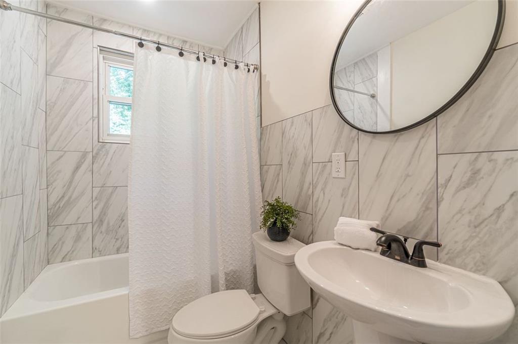 1226 Thomas Road Decatur, GA 30030 - Photo 36 of 38 a bathroom with a sink toilet and shower