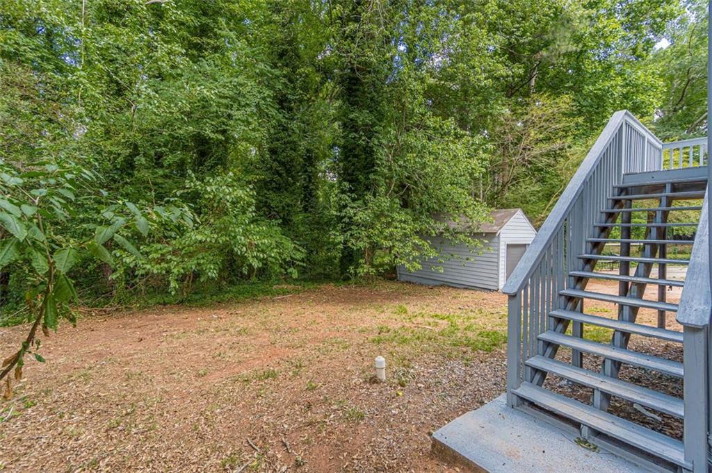 1226 Thomas Road Decatur, GA 30030 - Photo 10 of 38 a view of backyard with wooden fence and trees