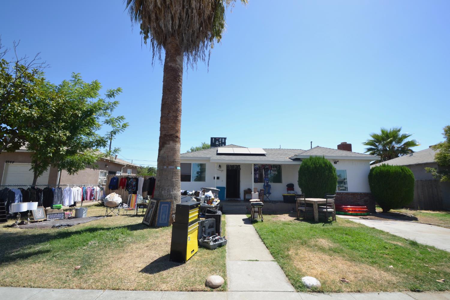 2555 South Lotus Avenue Fresno, CA 93706 - Photo 1 of 15 a front view of a house with garden and trees