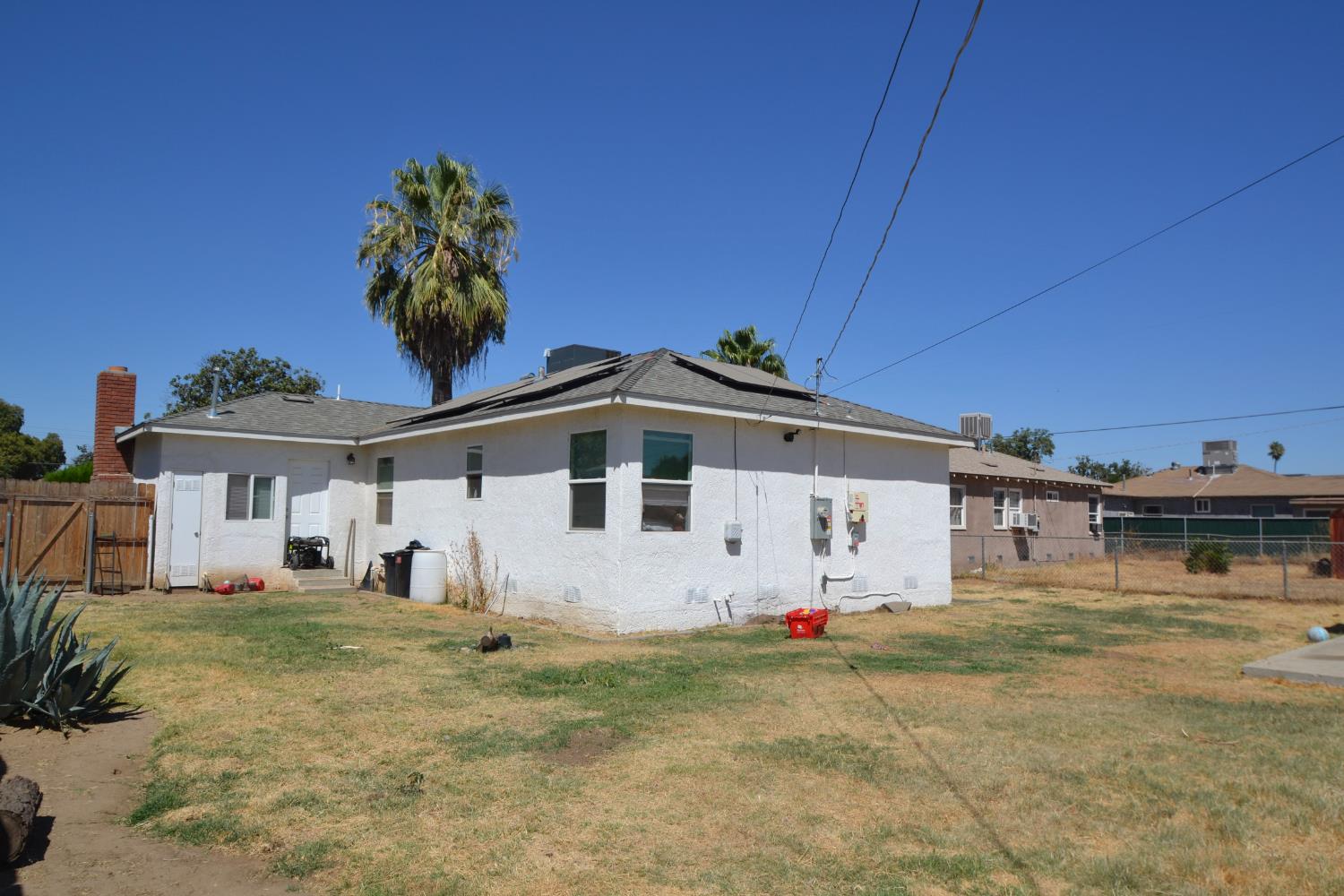 2555 South Lotus Avenue Fresno, CA 93706 - Photo 14 of 15 a view of a white house with a white fence