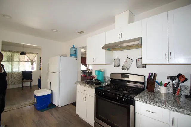 a kitchen with a stove and a refrigerator