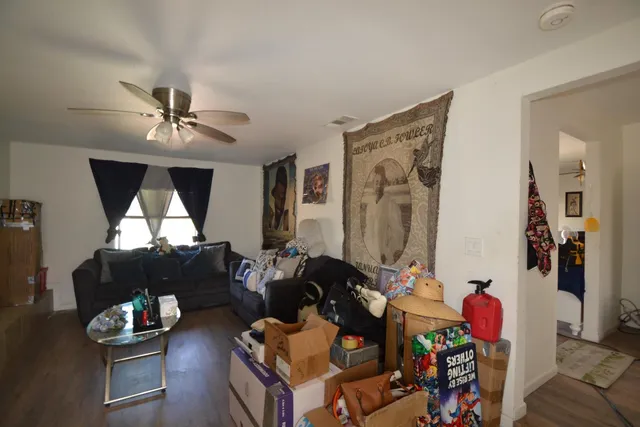 a living room with furniture and wooden floor