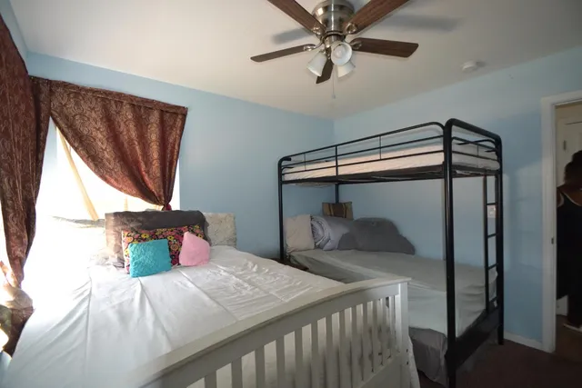 a bedroom with a bed and a window