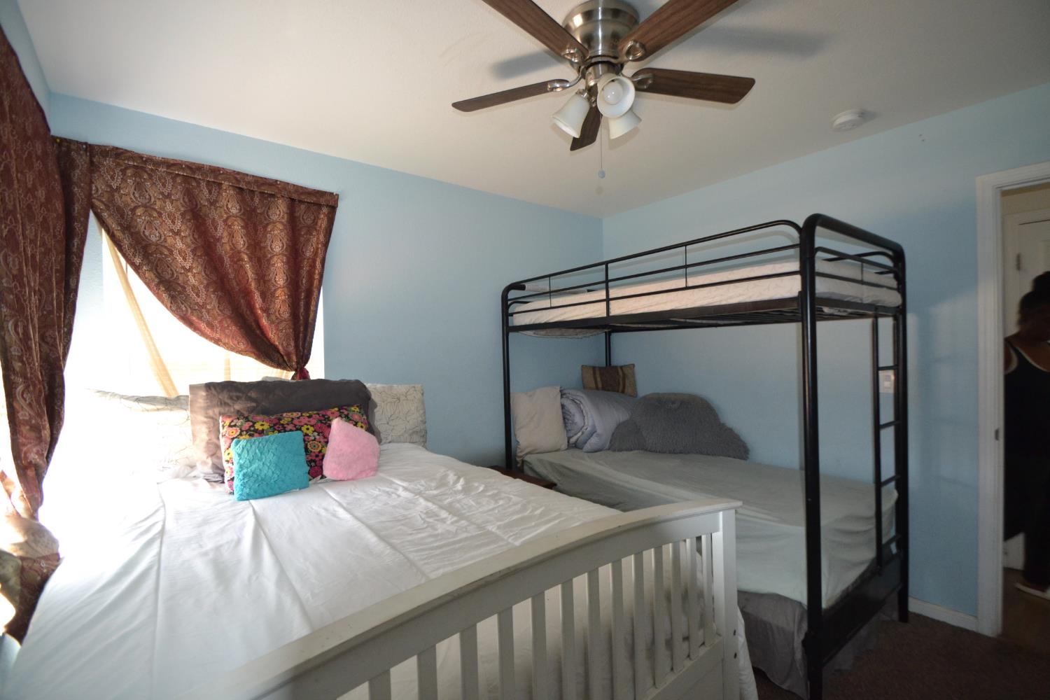 2555 South Lotus Avenue Fresno, CA 93706 - Photo 9 of 15 a bedroom with a bed and a window