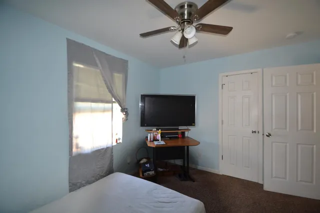 a bedroom with a workspace