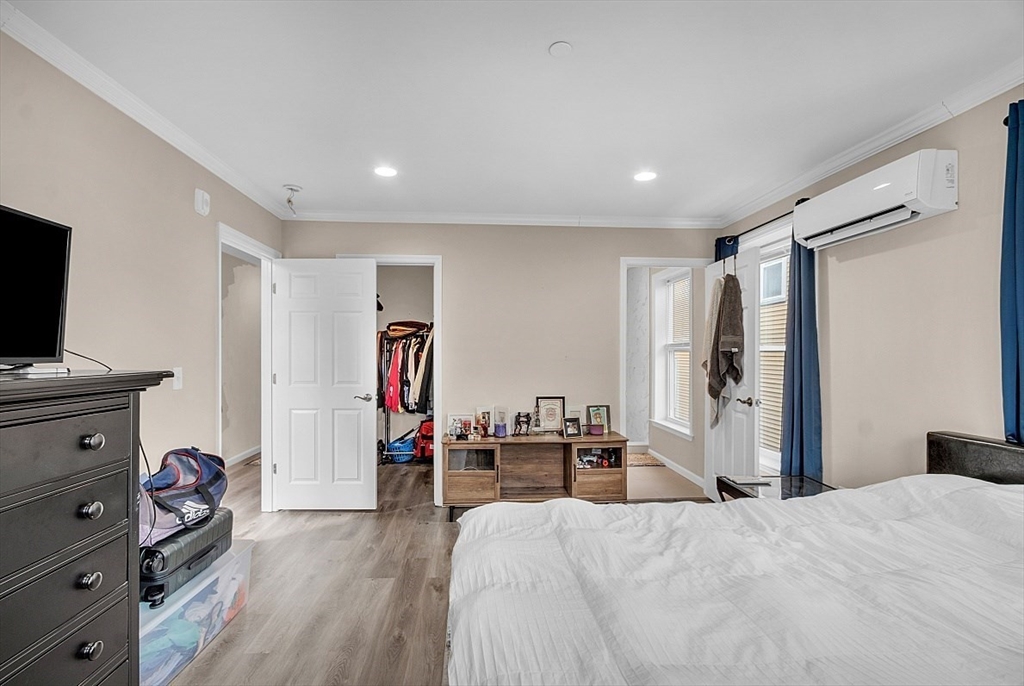 3 Elm Street, Unit 4 Boston, MA 02122 - Photo 11 of 24 a bedroom with furniture and a flat screen tv