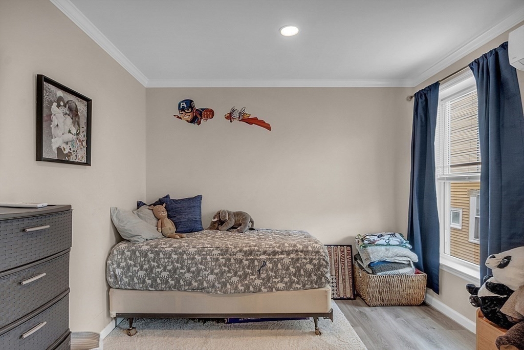 3 Elm Street, Unit 4 Boston, MA 02122 - Photo 13 of 24 a bedroom with a bed and wooden floor